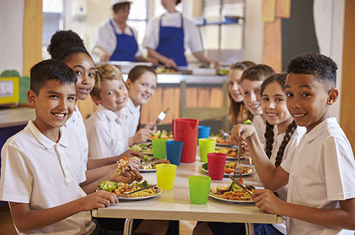 content-image-school-children-sitting-in-canteen-eating